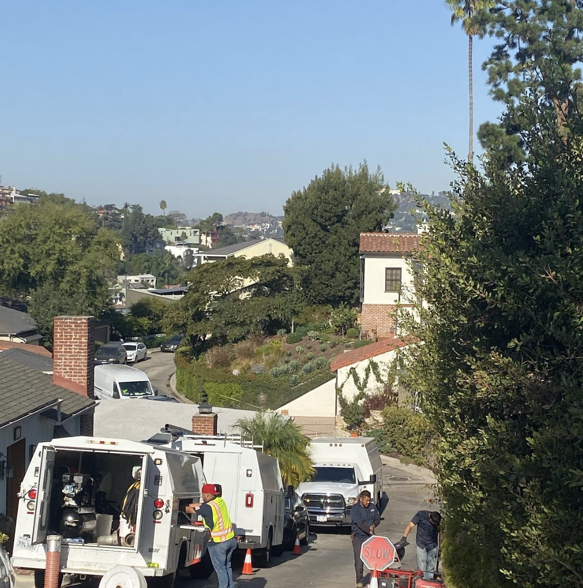 Premier 1 Plumbing sewer crew and trucks working a residential street in Los Angeles